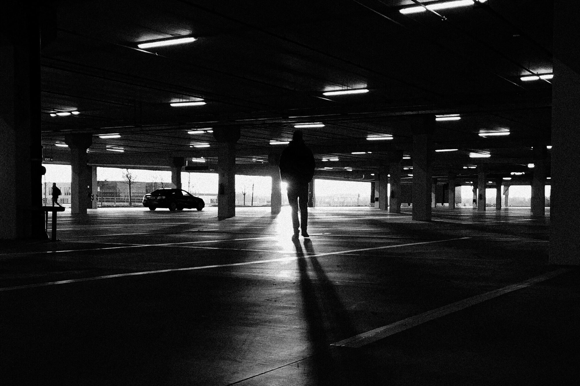 Man walking toward her car in dangerous parking lot, illustrating self defense awareness