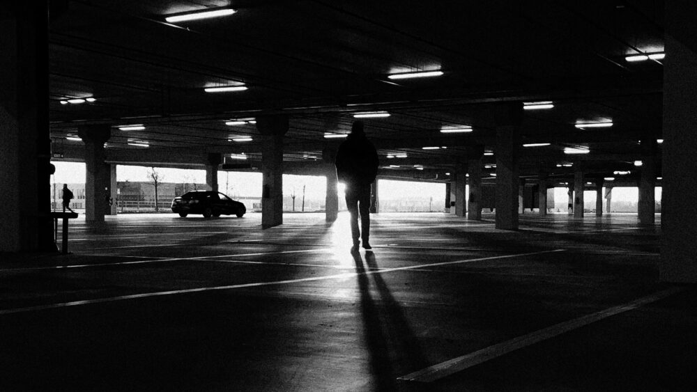 Man walking toward her car in dangerous parking lot, illustrating self defense awareness